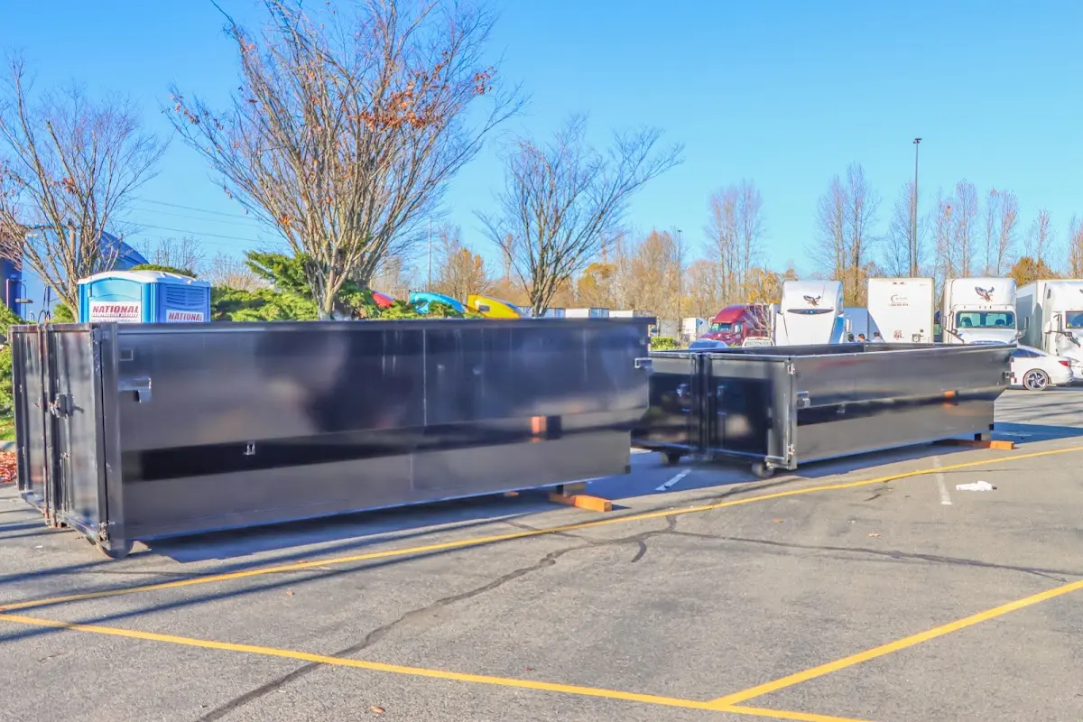 Professional dumpster rental service with roll-off container on residential driveway in Muskego